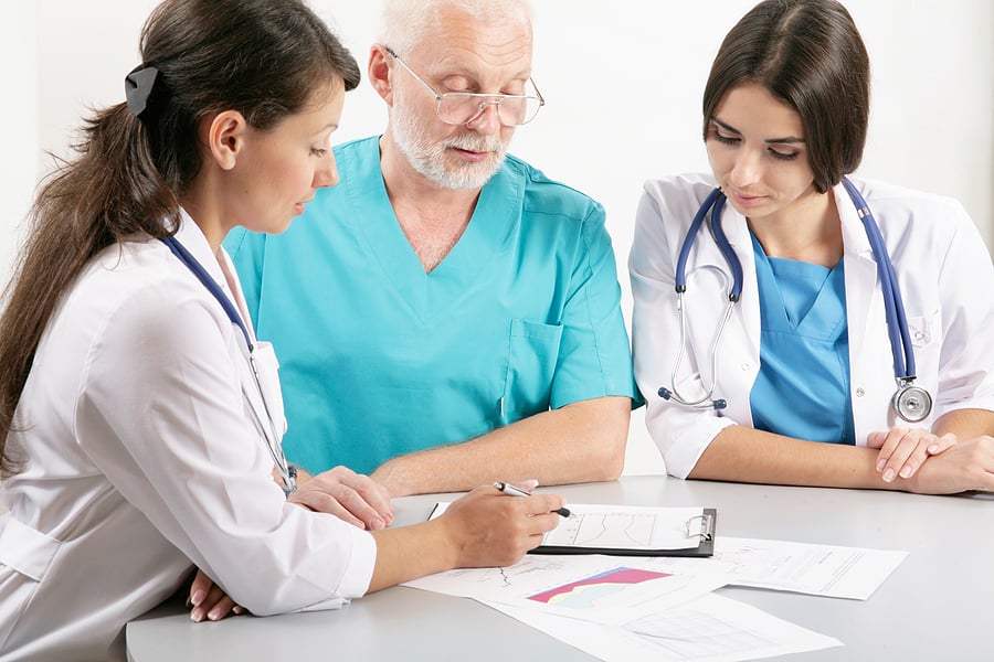 Medical team looking over a patient's health history.