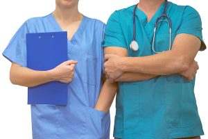 Male and female medical professionals wearing scrubs. 