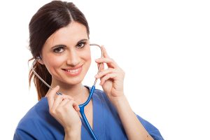 Smiling female medical professional wearing blue scrubs, holding a stethoscope. 